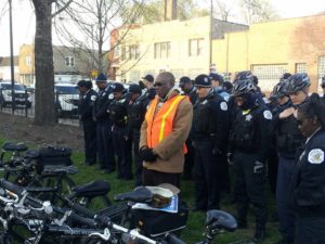Elder Willie Keys of the Parkway Gardens Christian Church in prayer with the 3rd District Chicago Police Department.